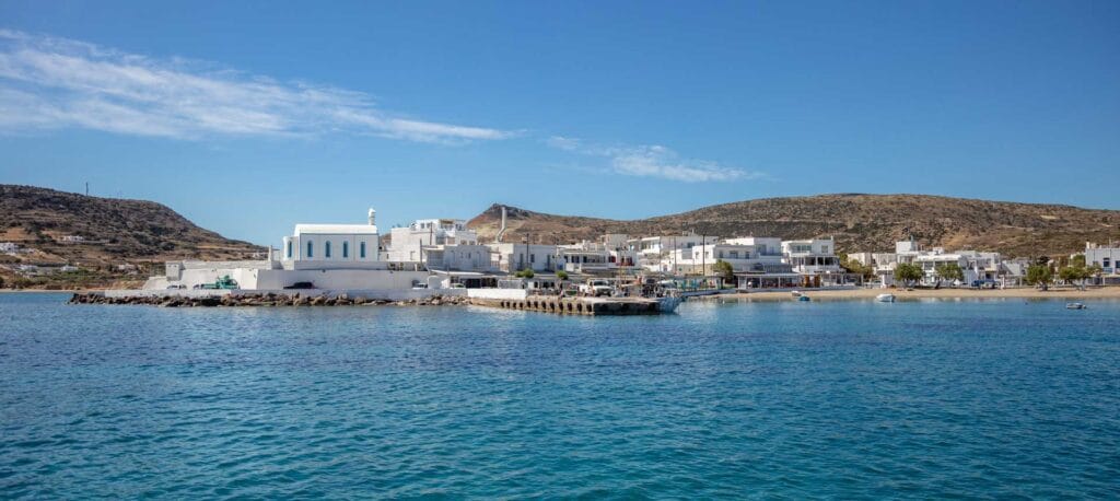 Waterfront restaurant tables along Pollonia harbour at sunset Milos Greece